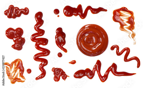 Ketchup splashes, group of objects. Arrangement of red ketchup or tomato sauce, isolated white background, top view. photo
