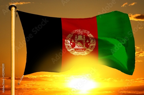 Afghanistan flag weaving on the beautiful orange sunset with clouds background