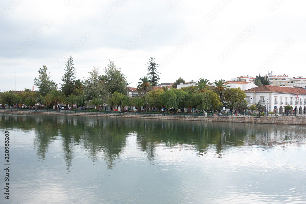 Fototapeta premium reflections in the river running through the city