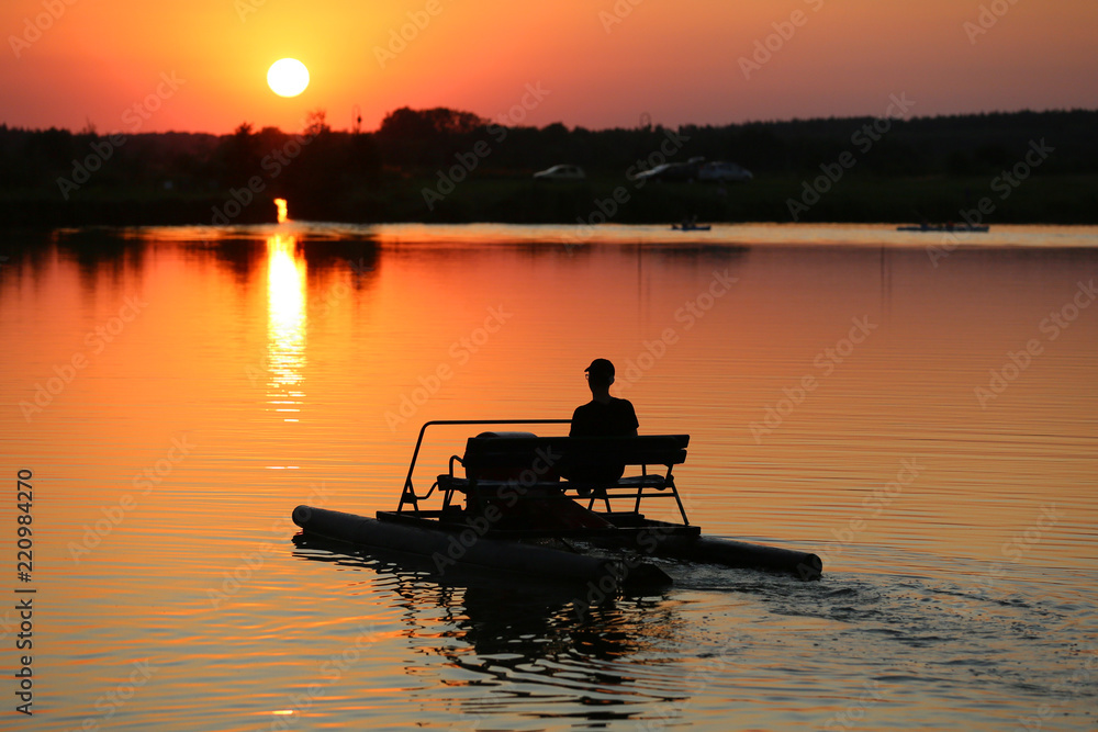 A canoeist floating on a large lake 
