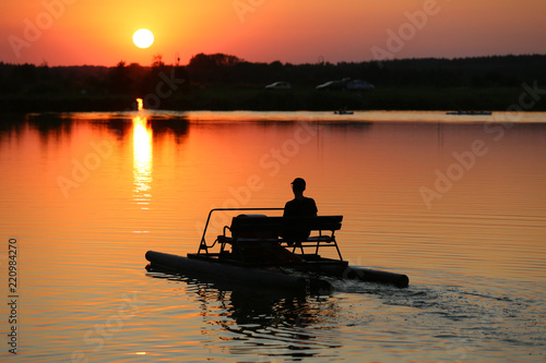 Fototapeta Naklejka Na Ścianę i Meble -  A canoeist floating on a large lake 