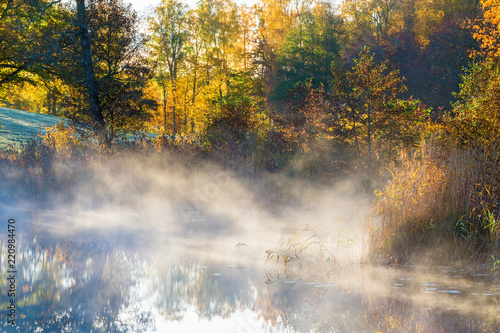 Morning fog by the lake in autumn