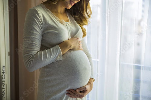 Young pregnant woman by the window Free Download Young pregnant woman by the window - GFXLoad