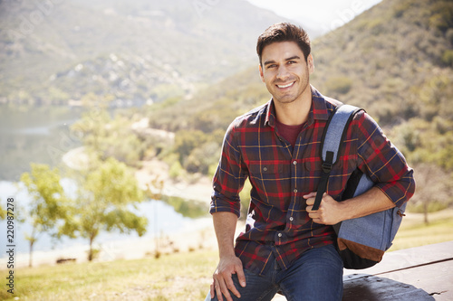 Young Hispanic man smiling during mountain hike, portrait #220987278