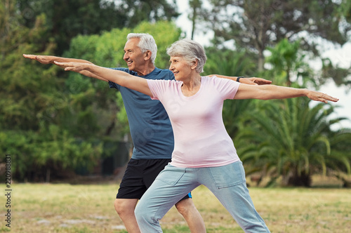 Old man and woman doing stretching exercise