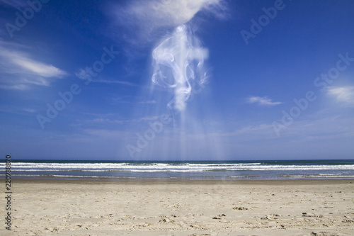 Blue sky in sunny day with clouds forming a large cross surrounded by lots of light and smoke, illustration with image montages