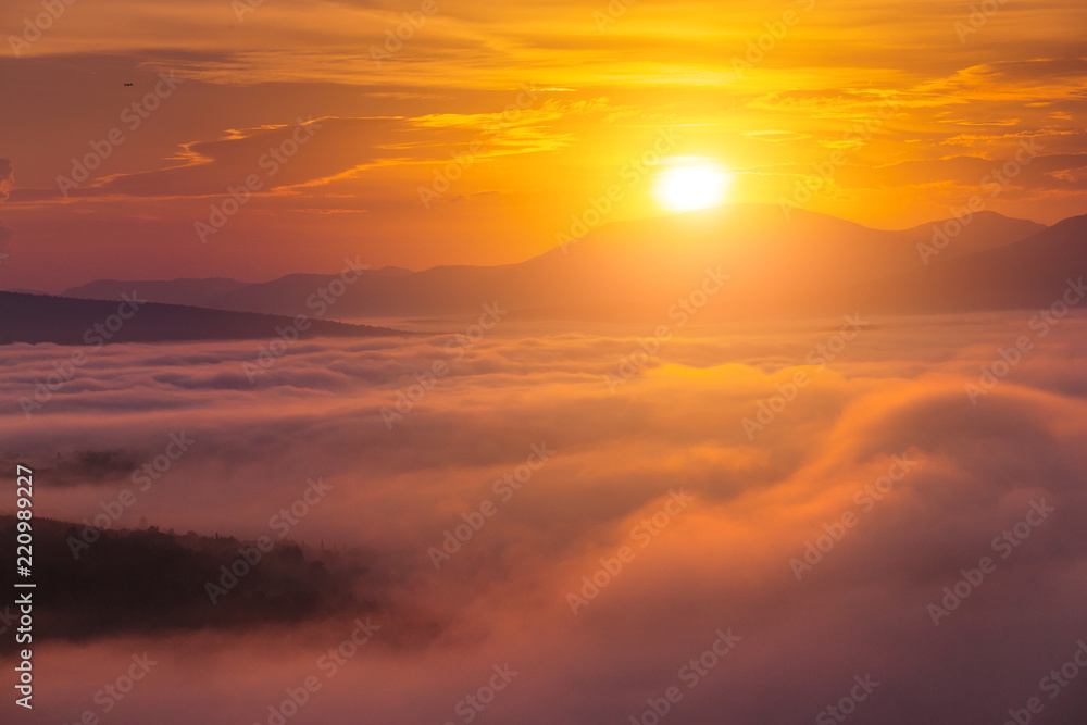 Colorful landscape in mountains with fog and sun