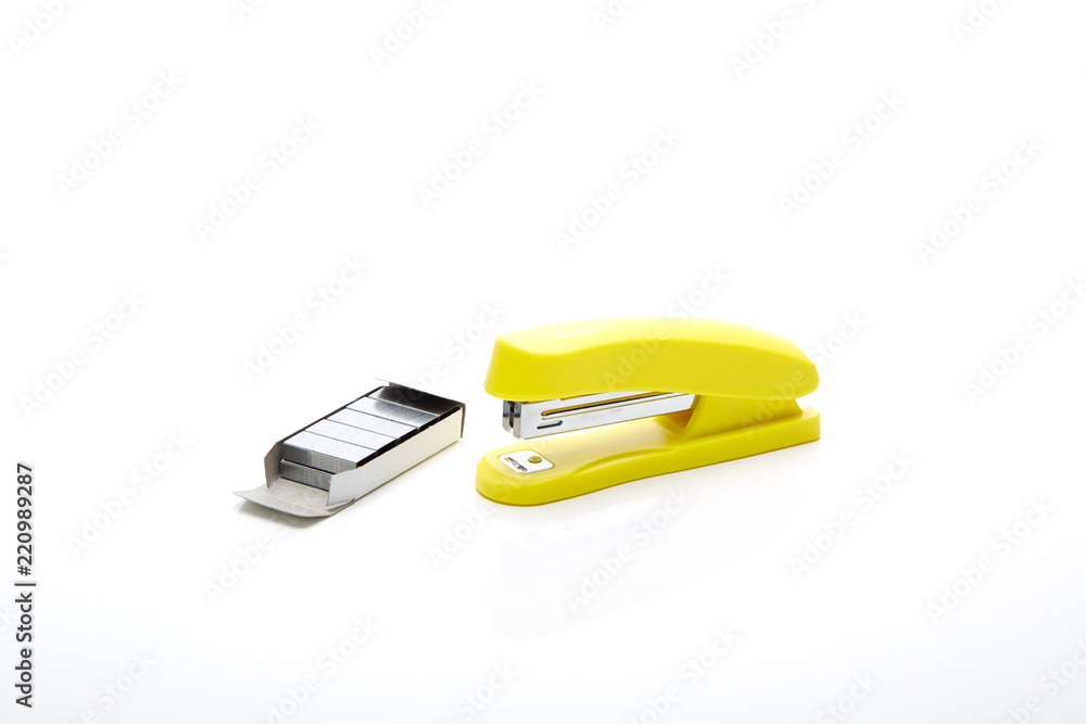 Yellow stapler on the white Yellow stapler on the white