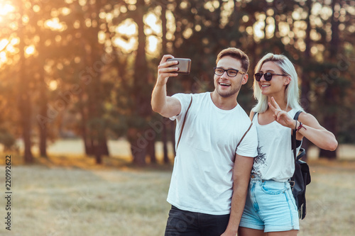 Young couple taking selfie with mobile phone