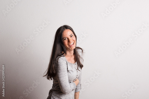 Portrait of a young beautiful woman in studio on a white background. © Halfpoint