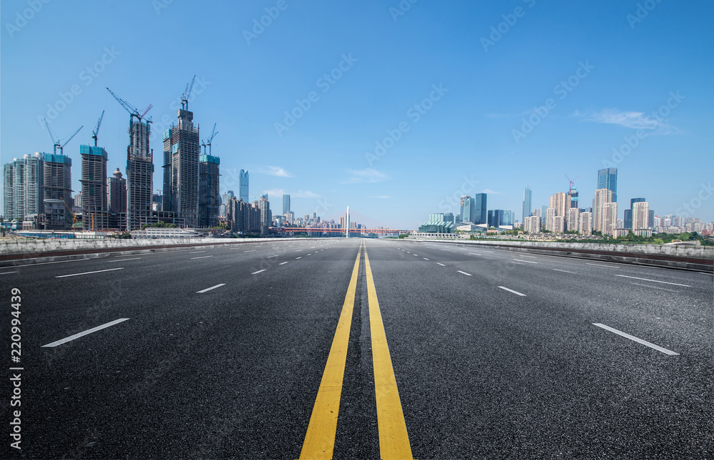 The expressway and the modern city skyline are in Chongqing, China.