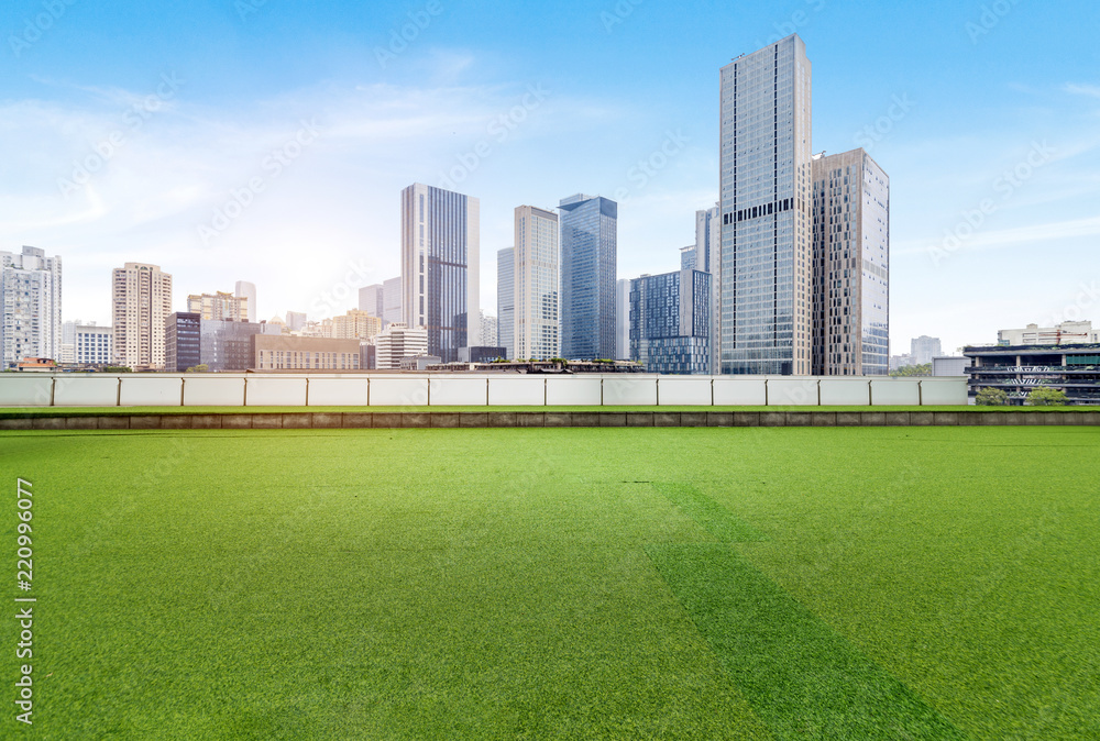 The square with lawn and the modern city skyline are in Chongqing, China.