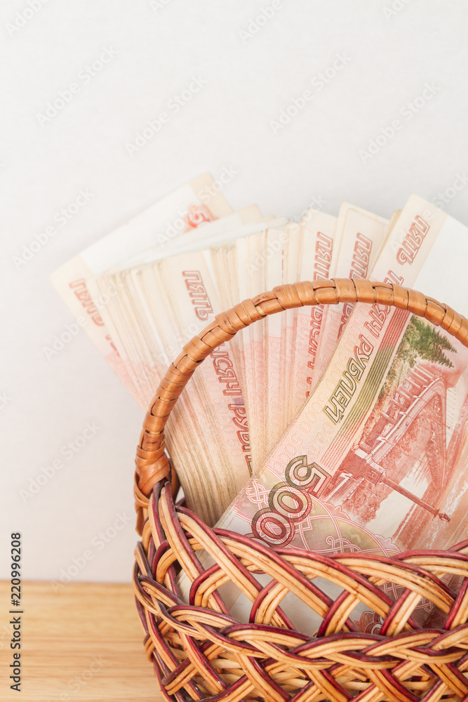 A lot of Russian money in denominations of five thousand rubles are in the basket - obrazy, fototapety, plakaty 