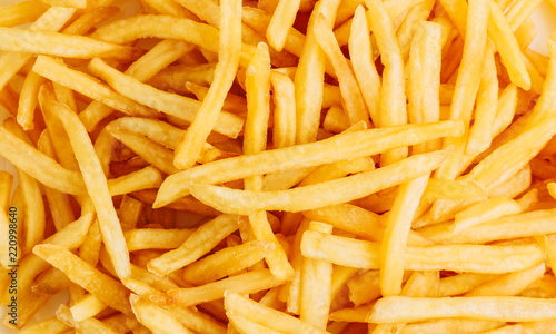 Yummy french fries as background. Flat lay, top view 