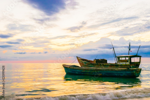 Old fishing boats floating near the coastline at sunset in Westmoreland, Jamaica