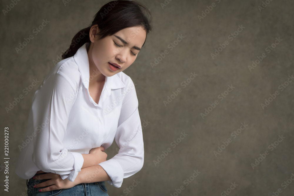 woman with stomach ache; sick woman suffering from stomachache, menstrual period cramp, abdominal pain, food poisoning, gastritis, acid reflux; asian young adult woman health care model woman with stomach ache; sick woman suffering from stomachache, menstrual period cramp, abdominal pain, food poisoning, gastritis, acid reflux; asian young adult woman health care model
