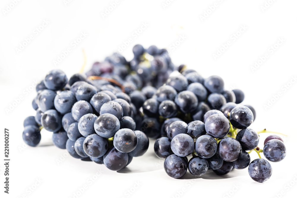 Raw dark grapes isolated on white background. Autumn abstractions.
