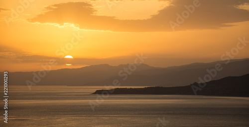 A sunrise over the Mediterranean sea and some mountains in Sicily 