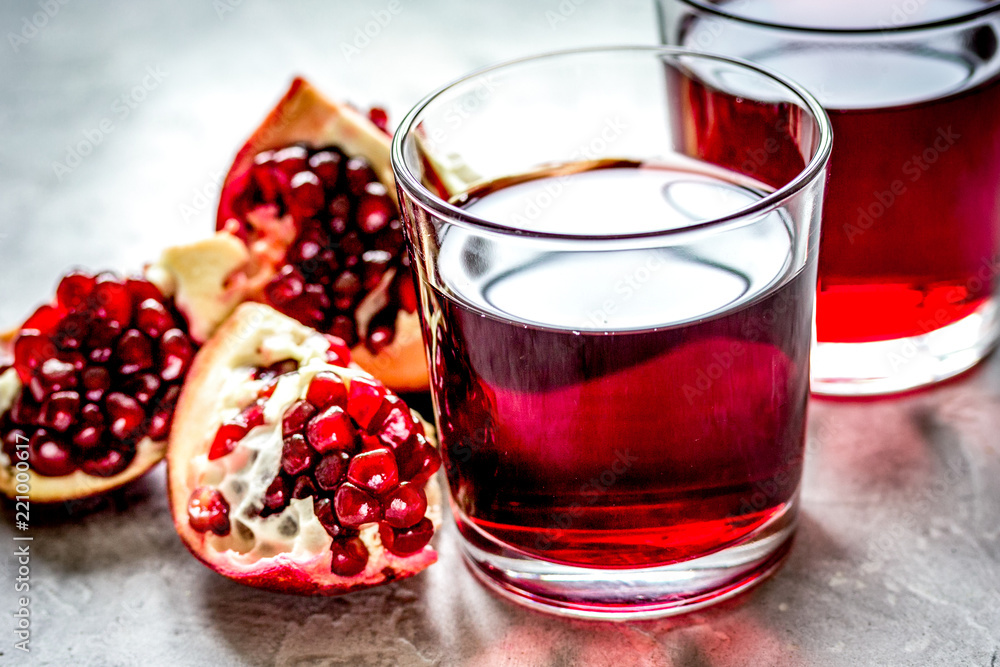 pomegranate juice with seed on stone table background pomegranate juice with seed on stone table background