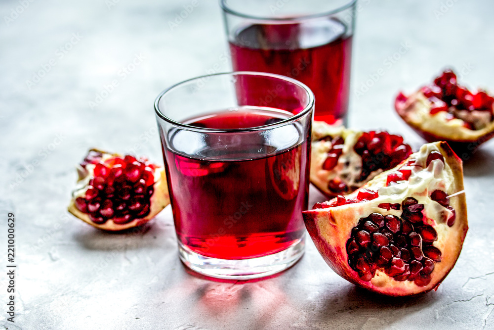 red fruit juice with fresh pomegranate on table background red fruit juice with fresh pomegranate on table background