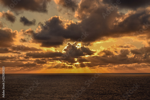 Glorious orange sky as sun rays spread across the horizon just before sunset on the Caribbean Sea.