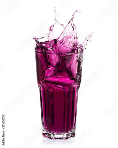 Cuadro en lienzo Grape juice splash out of glass isolated on white background.