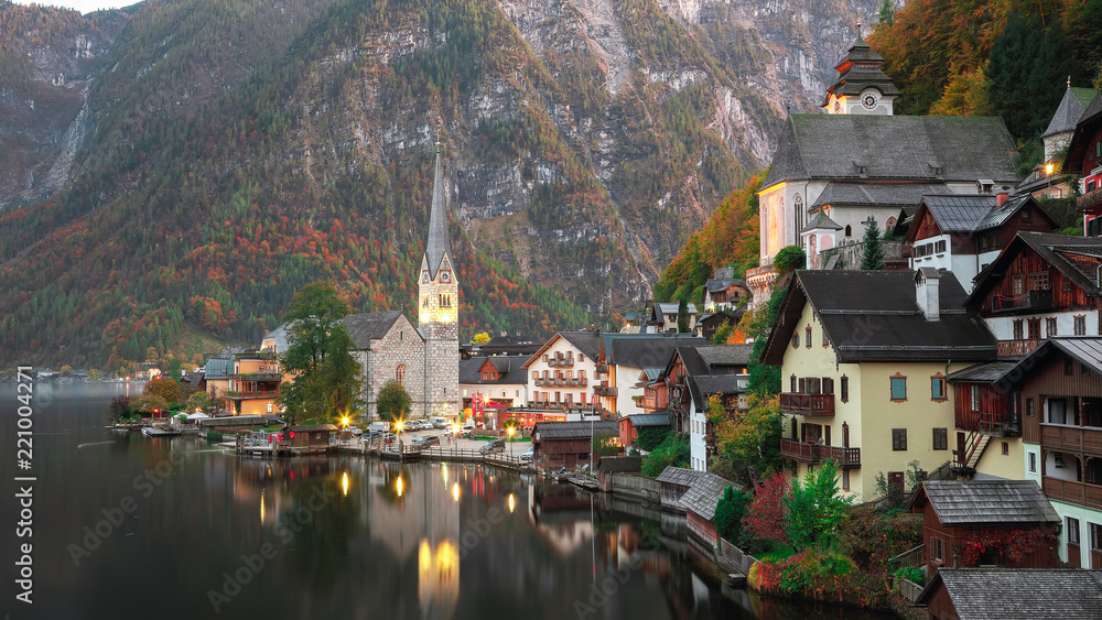 Classic postcard view of famous Hallstatt lakeside town reflecting in Hallstattersee lake in the Austrian Alps