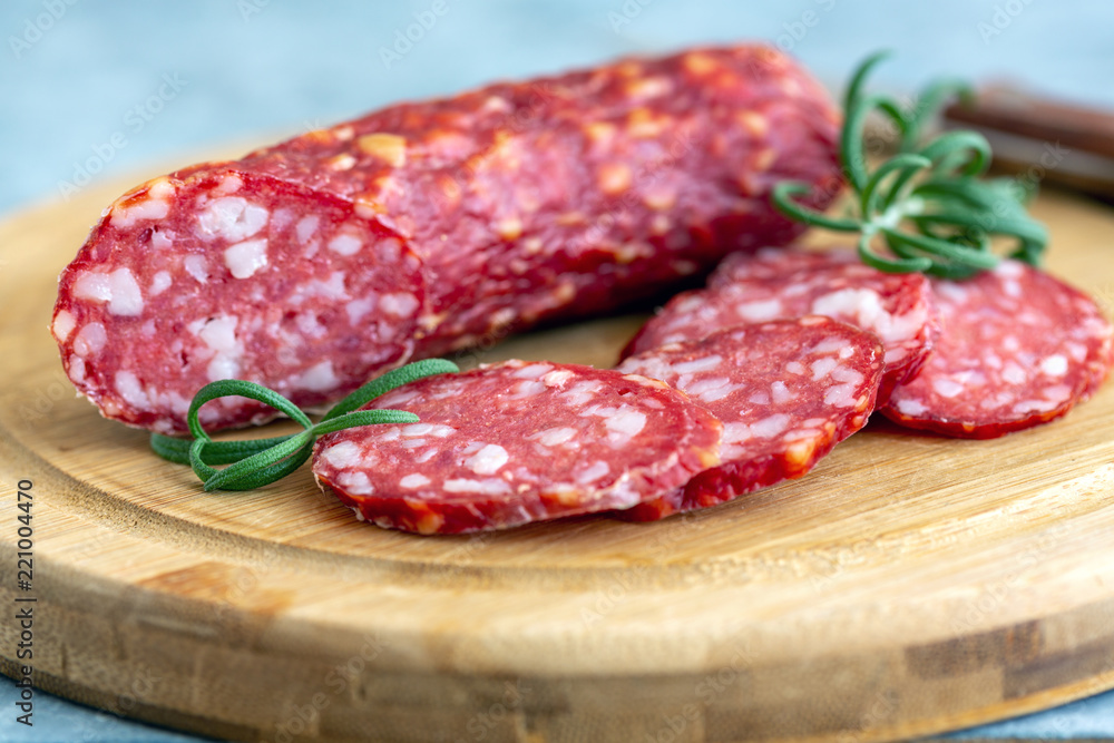 Slices of spicy salami and rosemary. Slices of spicy salami and rosemary.
