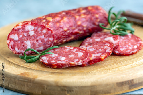 Slices of spicy salami and rosemary.