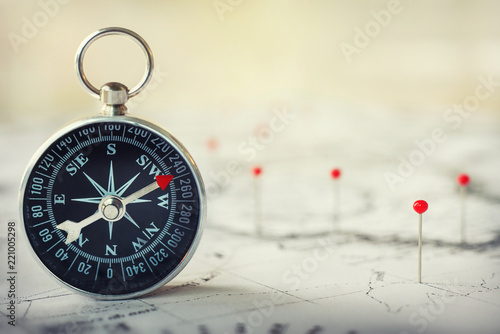 Magnetic compass on world map.Travel, geography, navigation, tourism and exploration concept background. Macro photo. Very shallow focus.