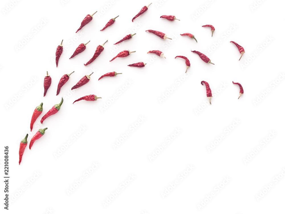 Dried chili peppers are on a white background in the form of a comet. At the bottom of the composition there is an empty space for the text. Dried chili peppers are on a white background in the form of a comet. At the bottom of the composition there is an empty space for the text.