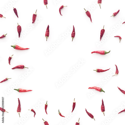 Dried chili peppers are on a white background. There is blank space for text in the center of the composition.