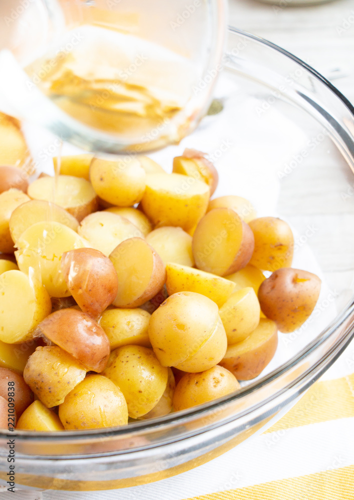 Boiled Potatoes Being Poured with Oil Boiled Potatoes Being Poured with Oil