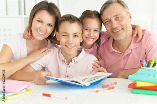 Portrait of big happy family doing homework