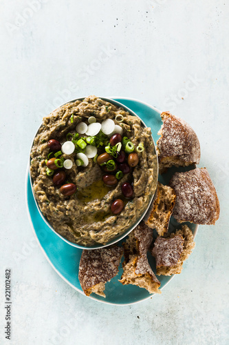 Appetizer with baba ganush of eggplant, olives from kalamata, green onions and fresh rye bread. Mediterranean snack. Vegan healthy food photo