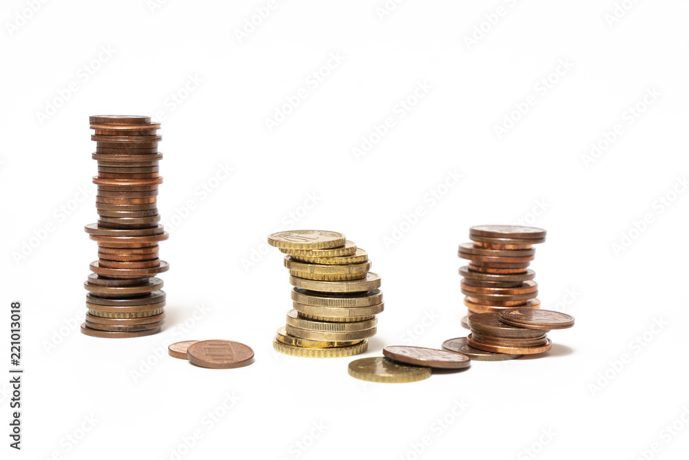 some stacked euro coins on a white surface some stacked euro coins on a white surface