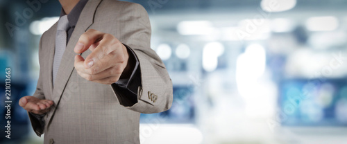 businessman workimg on VR blank wide touch screen computer on office blur background. photo