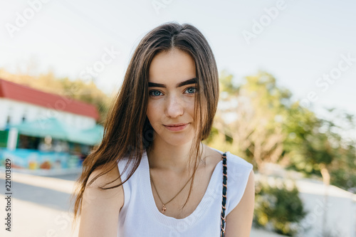 Portrait of beautiful young woman dressed in white top