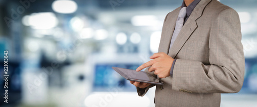 businessman workimg on VR blank wide touch screen computer on office blur background. photo