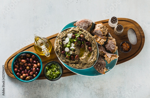 Appetizer with baba ganush of eggplant, olives from kalamata, green onions and fresh rye bread. Mediterranean snack. Vegan healthy food photo