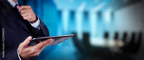 businessman workimg on VR blank wide touch screen computer on office blur background. photo