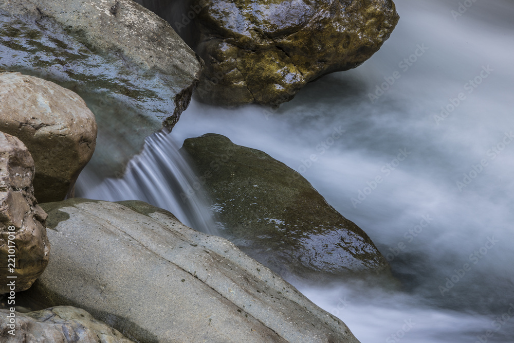 Fototapeta premium A long exposure of a river flowing along rocks