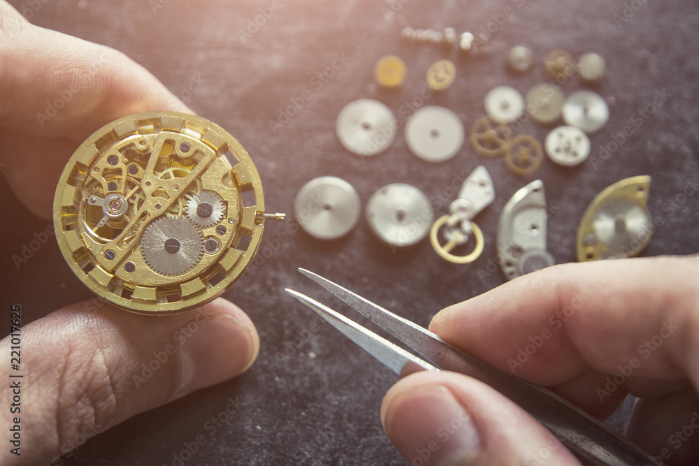 Watchmaker is repairing the mechanical watches in his workshop Watchmaker is repairing the mechanical watches in his workshop