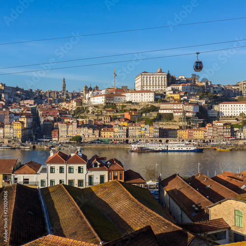 Porto, Portugal - Januaryt 19, 2018: View of the historic city of Porto with famous bridge Ponte dom Luis, cable cars and boats on Douro river, Portugal