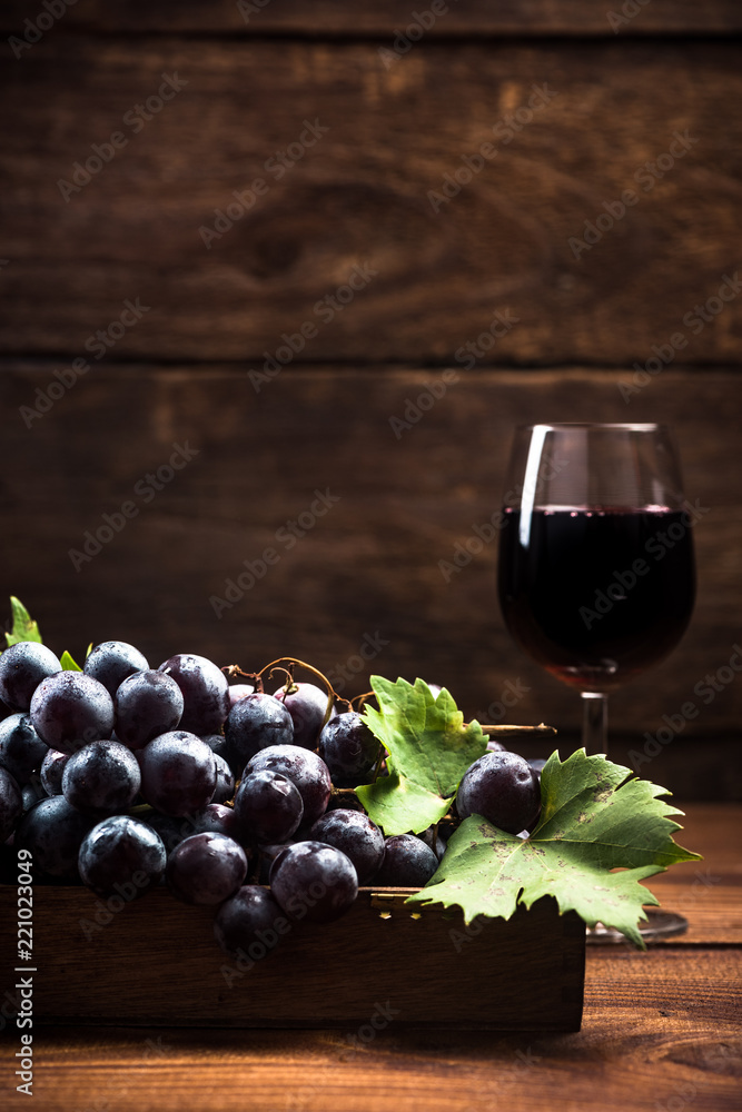 Fresh vine grapes and glass of red wine