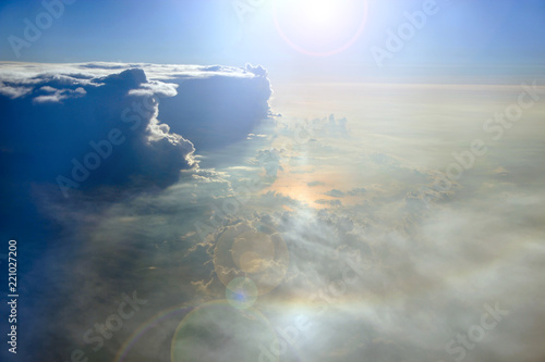 Wonderful view from window of plane in morning sun over clouds © alexmak