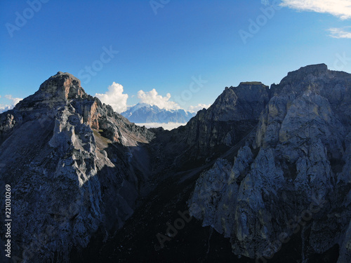 Mountain peaks of the Caucasus towering above the clouds. Fog in the mountain gorge.