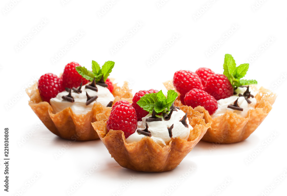 Brandy snap baskets with ice cream and berries isolated on white Brandy snap baskets with ice cream and berries isolated on white