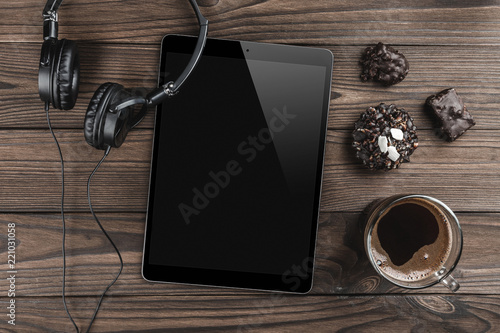 Wallpaper Mural Working desk table concept. Office desk table with headphone, tablet, biscuits and cup of coffee. Flat lay photo. Top view with copy space Torontodigital.ca