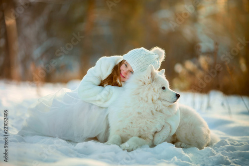 Winter girl portrait with samoyed dog